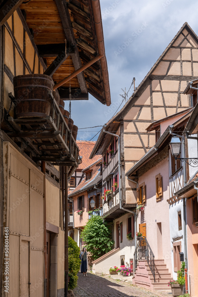 narrow cobblestone street with colorful historic half-timbered houses