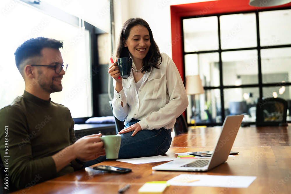 Businessman and businesswoman on coffee break. Colleagues enjoy in fresh coffee Businessman and businesswoman on coffee break. Colleagues enjoy in fresh coffee