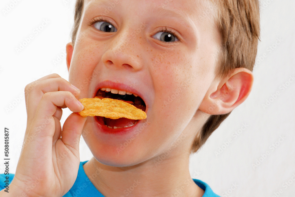 Happy kid eating potato chip portrit Happy kid eating potato chip portrit