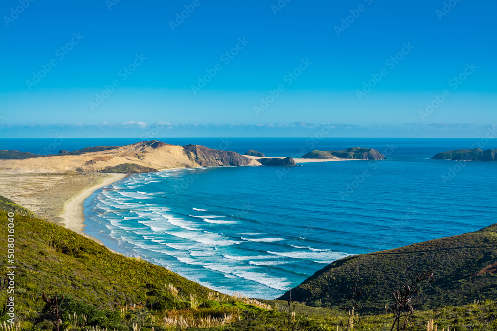 Stunning view over Te Werahi Beach and Cape Maria Van Diemen from a high vantage point in Cape Reinga on a bright winter day. North Island, New Zealand