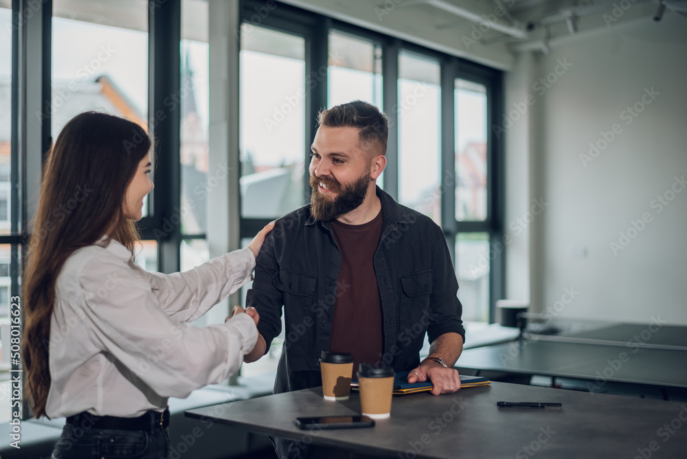 Businesspeople shaking hands after the meeting in the office