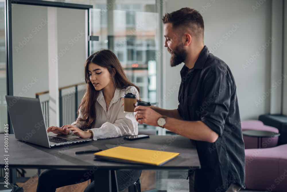 Two business colleagues having a meeting in the open space office Two business colleagues having a meeting in the open space office