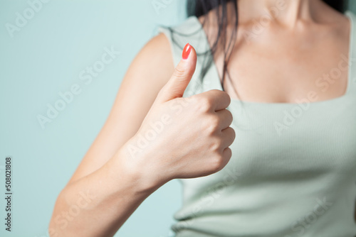 young woman showing thumb up.