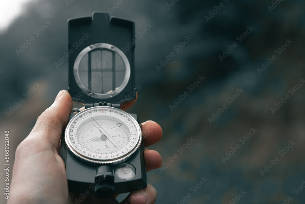 Naklejka premium compass in hand find way destination