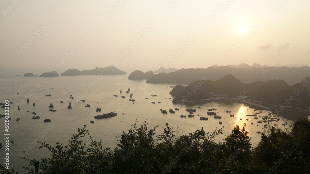 Sunset and night time light at Hạ Long Bay in northeast Vietnam.