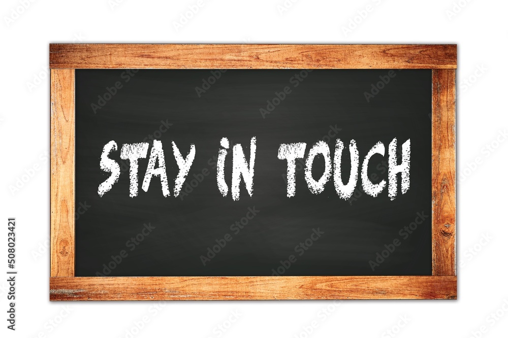 Fototapeta premium STAY IN TOUCH text written on wooden frame school blackboard.