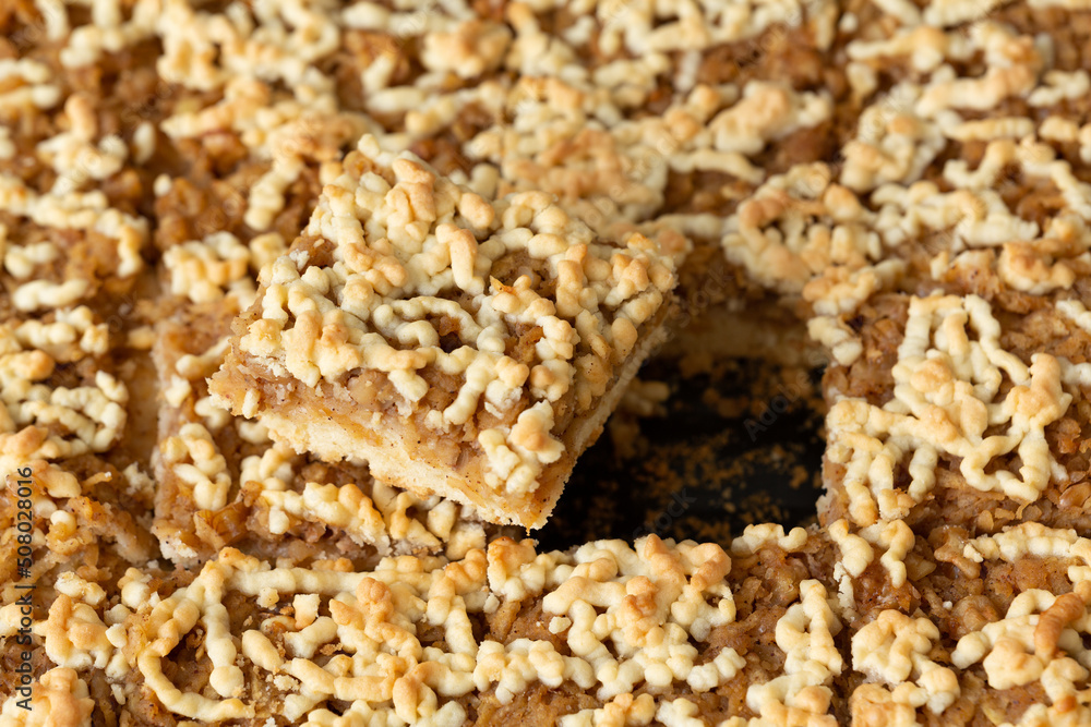 Square slice apple pie with walnut in selective focus. Delicious looking apple pies sliced squarely. Breakfast or after-dinner dessert concept. Square slice apple pie with walnut in selective focus. Delicious looking apple pies sliced squarely. Breakfast or after-dinner dessert concept.