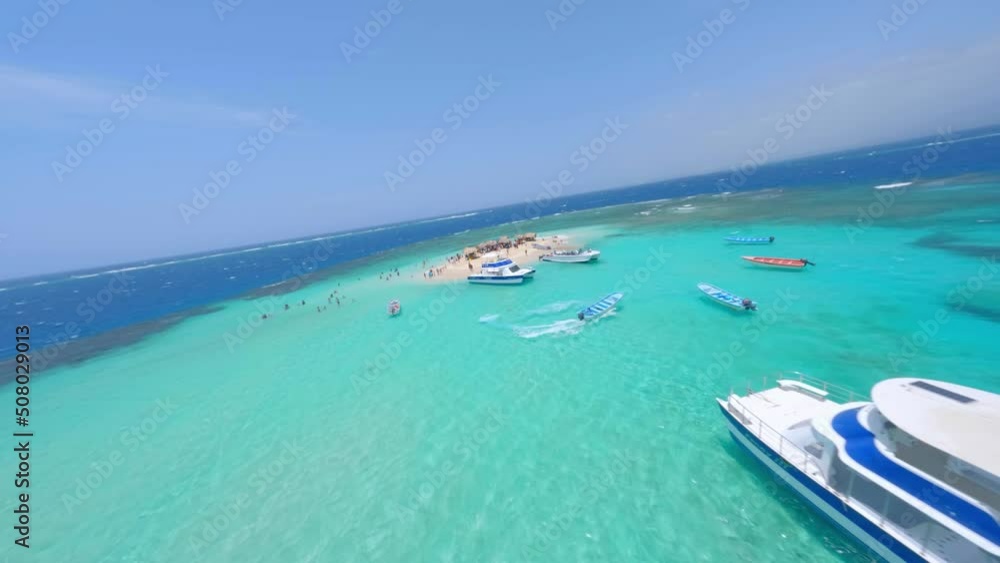 Coral islet sticks out above coral reef in Caribbean, Cayo Arena; FPV drone Coral islet sticks out above coral reef in Caribbean, Cayo Arena; FPV drone