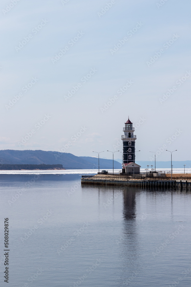 Lighthouse in the harbor of Lake Baikal near the village of Turka on a spring day