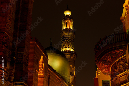 Arabic architecture in old town of Cairo on El-Moez Street - Mosque and Khanqah of al-Sultan al-Zahir Barquq. Landmarks of ancient muslim culture with arabesque and traditional ornaments on the walls. photo
