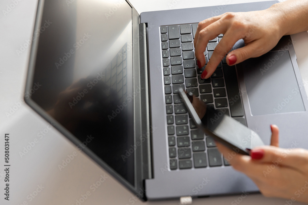 close up of female hands on laptop keyboard, woman holding smartphone. business concept close up of female hands on laptop keyboard, woman holding smartphone. business concept