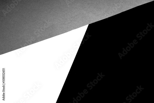 Black white and grey papers forming triangle shape textured background