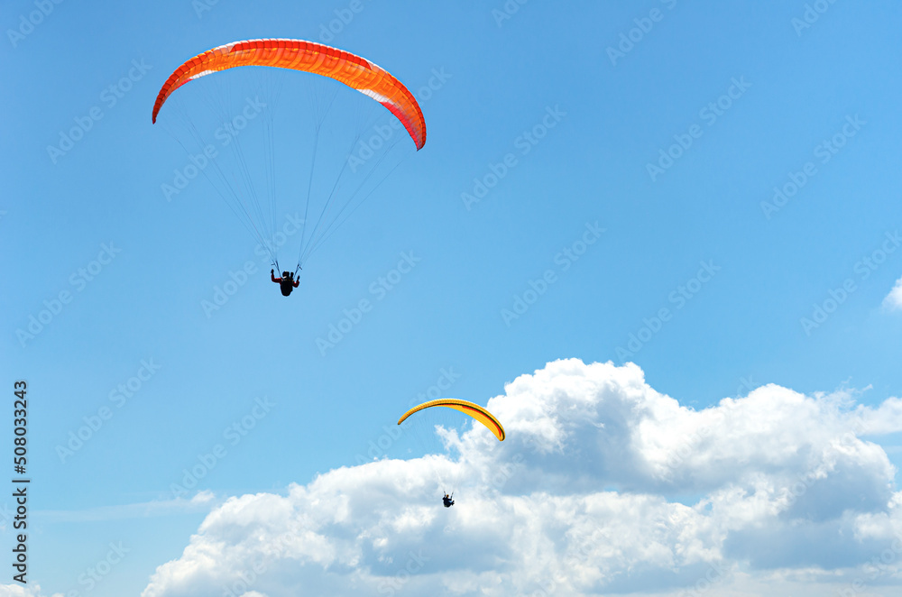 Paragliders in flight against a beautiful sky. Paragliders in flight against a beautiful sky.