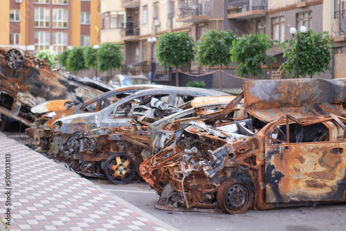 car graveyard. Burnt and blown up car. Cars damaged after shelling from russian invasion. War between Russia and Ukraine. Terror attack bomb shell. Disaster area irpin bucha photo