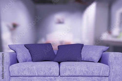 Photo toned in pantone color of the year 2022 very peri. Cozy violet sofa.