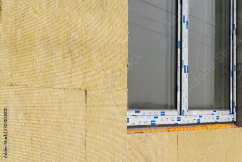 Layer of thermal insulation on the wall of the house outside. Mineral wool panels.