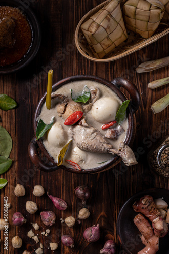 Opor Ayam from Indonesia on a wooden table. Top View. photo