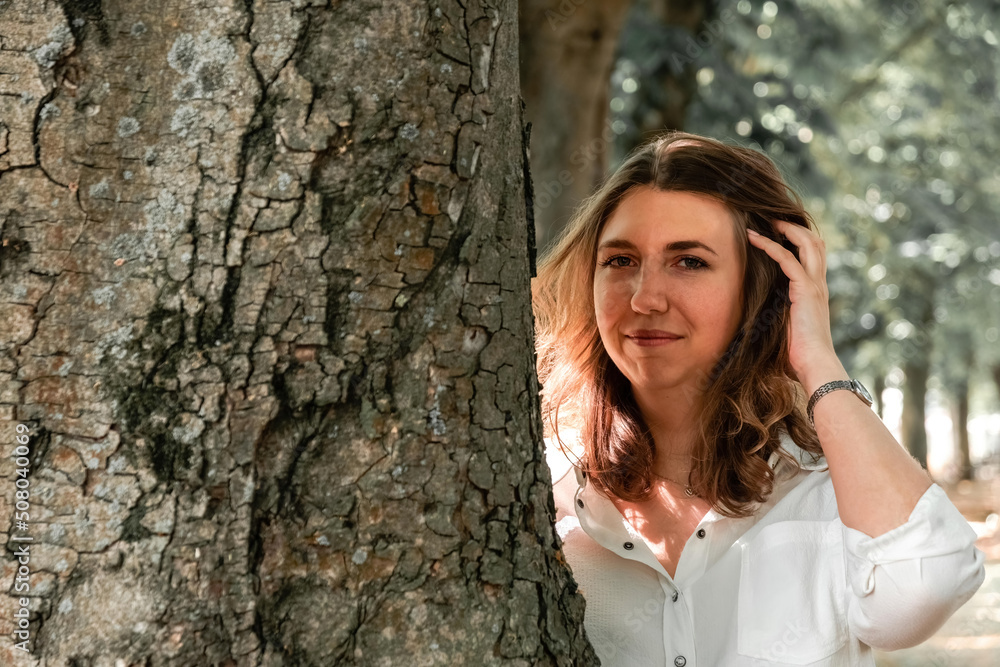 a pretty woman on a tree trunk a pretty woman on a tree trunk