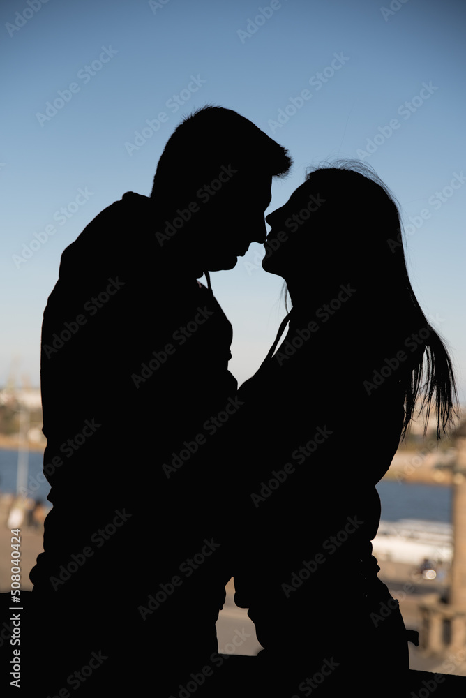 man and woman are hugging. silhouette