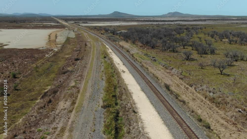 Railway crossing rural landscape of St Lawrence, Clairview in Australia. Aerial forward Railway crossing rural landscape of St Lawrence, Clairview in Australia. Aerial forward