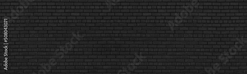 Old black shabby brick wall wide texture. Dark masonry panorama. Brickwork panoramic grunge background