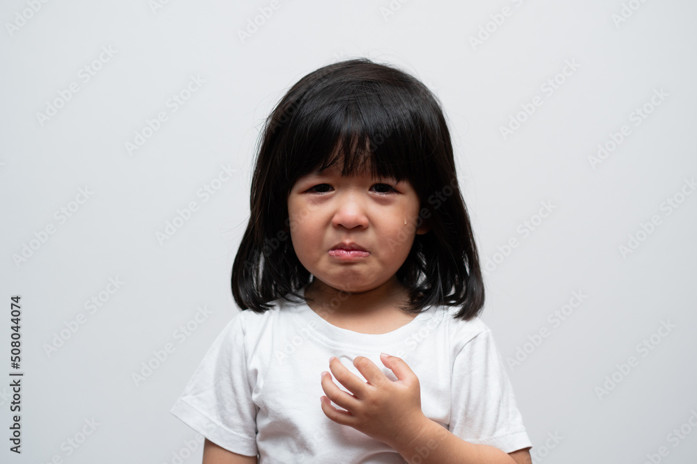 Portrait of Asian angry, sad and cry little girl on white isolated background, The emotion of a child when tantrum and mad, expression grumpy emotion. Kid emotional control concept Portrait of Asian angry, sad and cry little girl on white isolated background, The emotion of a child when tantrum and mad, expression grumpy emotion. Kid emotional control concept