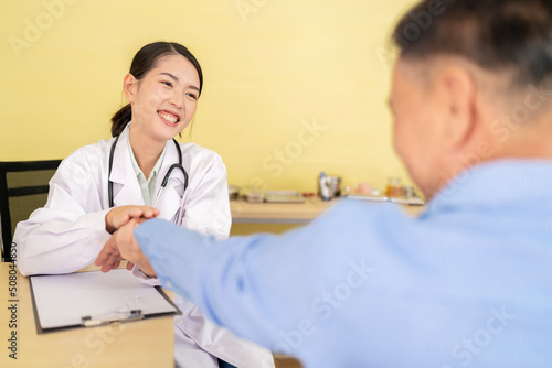 Asian female doctor talking to the elderly and physical examination To maintain health with a smile, the concept is health care. Elderly patients, adolescent doctors