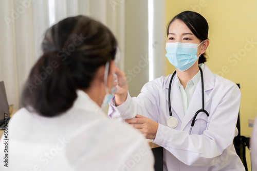 Asian female doctor talking to the elderly and physical examination To maintain health with a smile  the concept is health care. Elderly patients  adolescent doctors