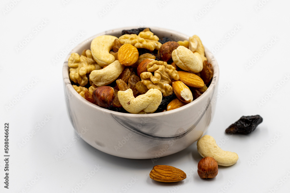 Mixed nuts on white background. Nuts, walnuts, raisins and cashews. close up Mixed nuts on white background. Nuts, walnuts, raisins and cashews. close up