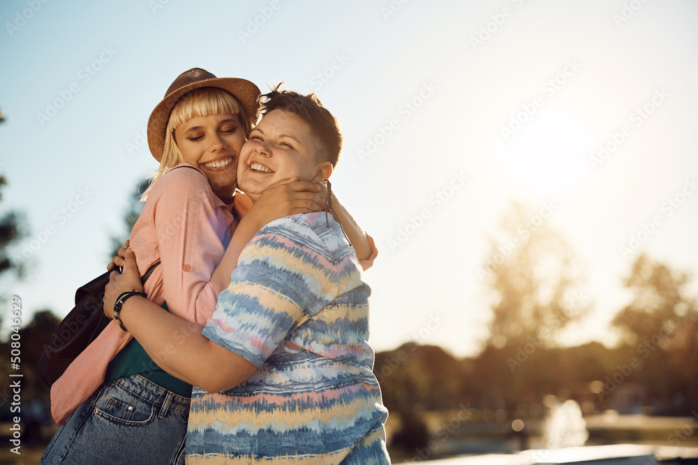 Obraz premium Happy lesbian couple in love embracing with affection in nature.