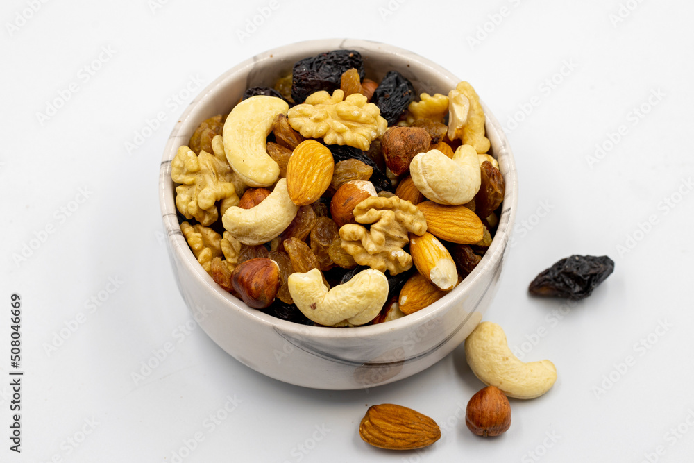 Mixed nuts on white background. Nuts, walnuts, raisins and cashews. close up Mixed nuts on white background. Nuts, walnuts, raisins and cashews. close up
