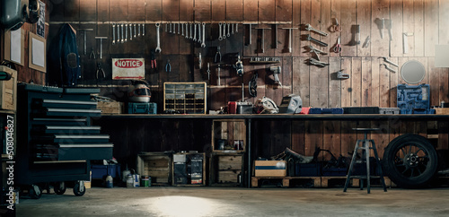 Workshop scene. Old tools hanging on wall in workshop, Tool shelf against a table and wall, vintage garage style