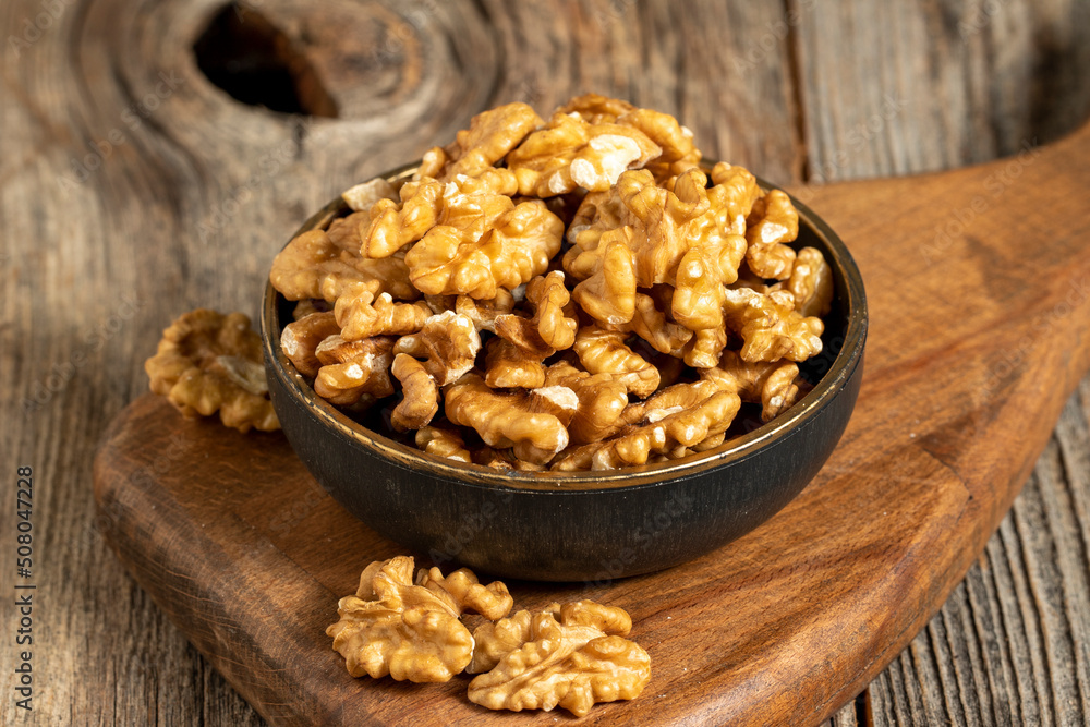 Walnut on wooden background. Close-up walnut kernel Walnut on wooden background. Close-up walnut kernel