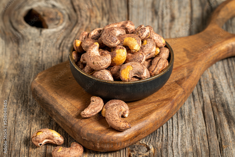 Shelled cashew on wooden background. Close-up of fresh cashews Shelled cashew on wooden background. Close-up of fresh cashews