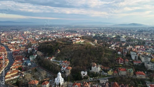 Aerial drone view of Barsov, Romania. The Citadel, medieval fortress on the top of a hill. Buildings around it, roads, greenery photo