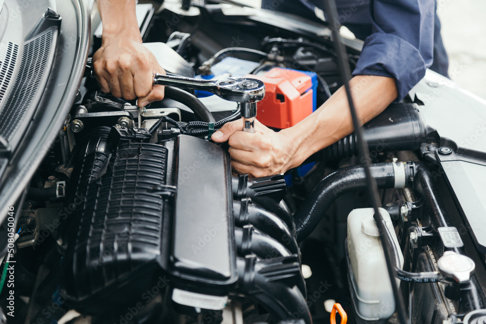 Automobile mechanic repairman hands repairing a car engine automotive workshop with a wrench, car service and maintenance,Repair service. Automobile mechanic repairman hands repairing a car engine automotive workshop with a wrench, car service and maintenance,Repair service.