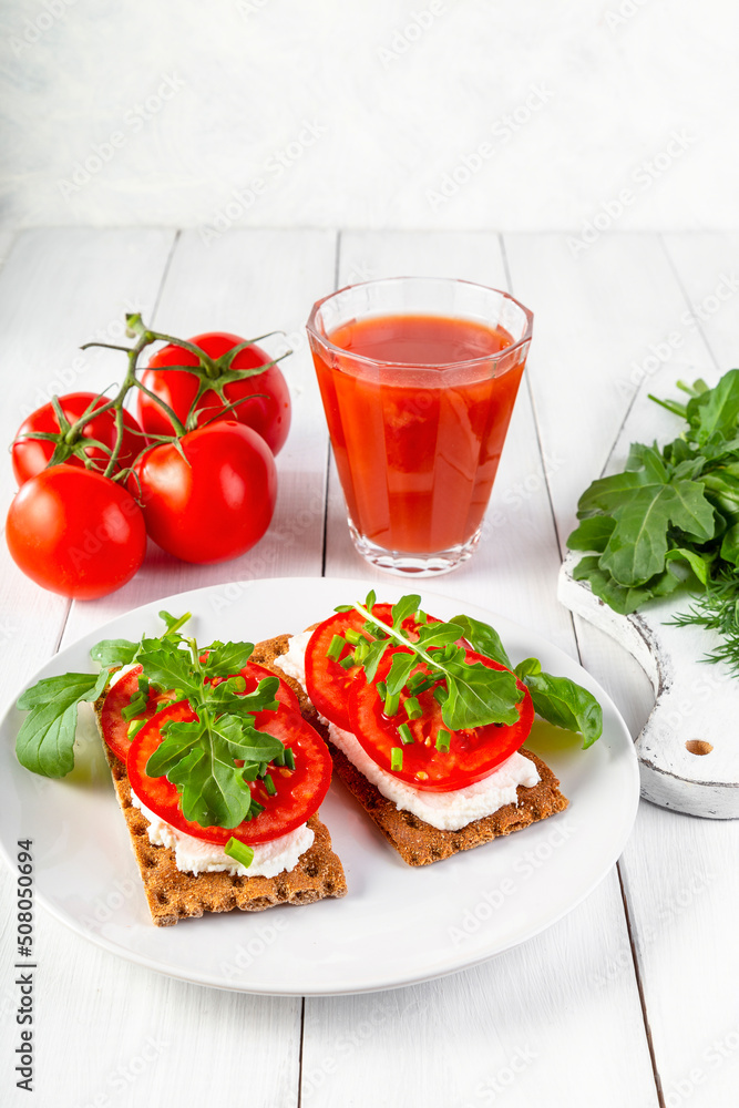 Crispbread with curd cheese, tomatoes, green onions, arugula and basilica. Delicious and healthy breakfast Crispbread with curd cheese, tomatoes, green onions, arugula and basilica. Delicious and healthy breakfast