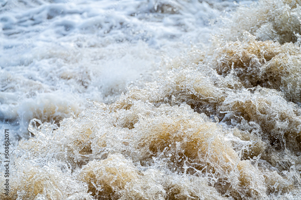 close up of flowing water, rapid water splashes of an white water river or stream, bubbly water close up of flowing water, rapid water splashes of an white water river or stream, bubbly water