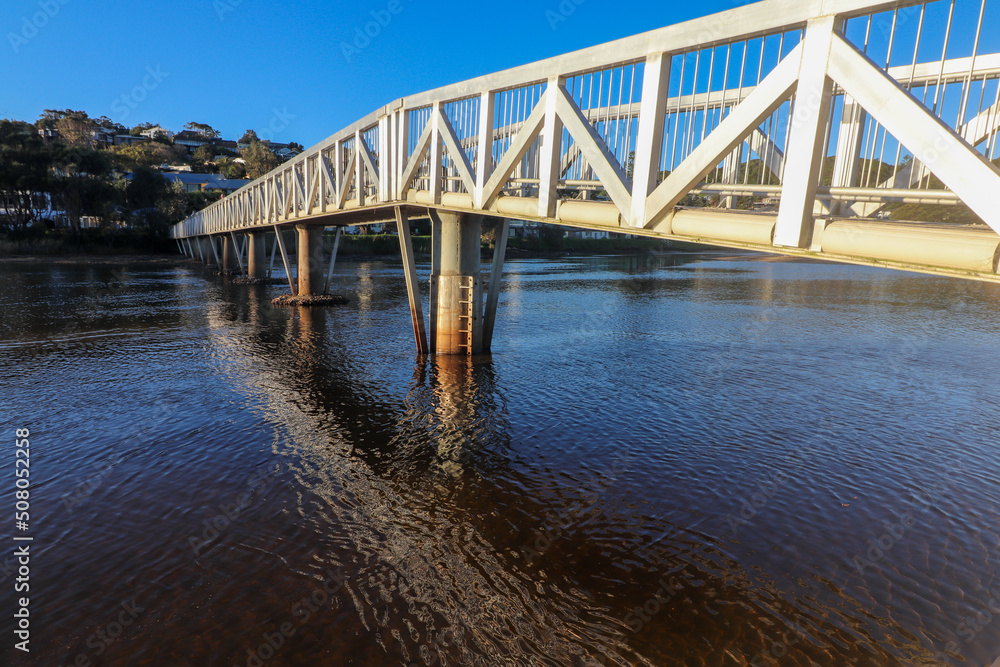 Obraz premium Pedestrian bridge over crooked river at Gerroa South Coast NSW 
