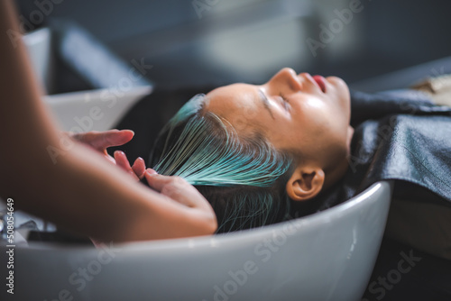 Fotobehang professional hairdresser woman are washing client hair in beauty salon, female h