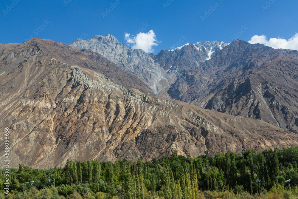 Beautiful landscapes of Hindukush mountains. Mountain ranges, gorges, river, green valleys, villages. Pakistan