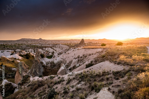dramatic sunset and rainclouds over the desert of Cappadocia with Uchisar © schame87