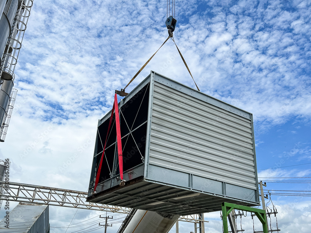 Lift and move the new cooling tower system to install. Lift and move the new cooling tower system to install.