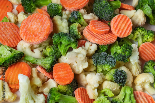 Heap of frozen vegetable mix close-up on a white background. Isolated