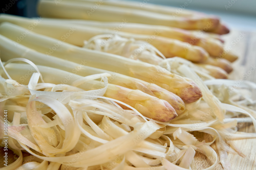Fresh peeled white asparagus directly from the field on a kitchen table Fresh peeled white asparagus directly from the field on a kitchen table