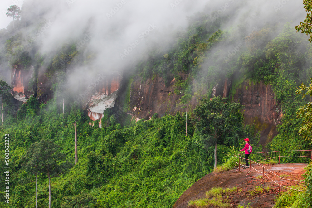 Fototapeta premium Young women hiking on Nakee Cliff, Phu Langka National Park, Nakon Phanom province,Thailand.