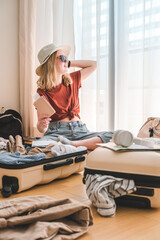 Travel. Staycation.local travel new normal.Girl packing luggage in suitcase and travel documents Travel,tourism,vacation,relocation.Mental health and travel vacation Film grain