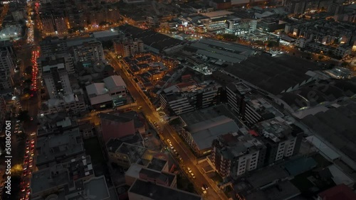 Stunning aerial tilt-up reveals vast Quito city at twilight with traffic