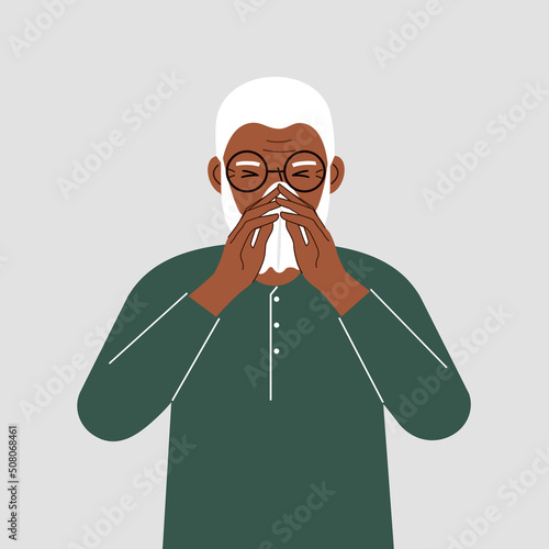 A grandfather covers his nose with his hands with a handkerchief. The concept of a sick person, sneezing, seasonal allergies, bad smell.