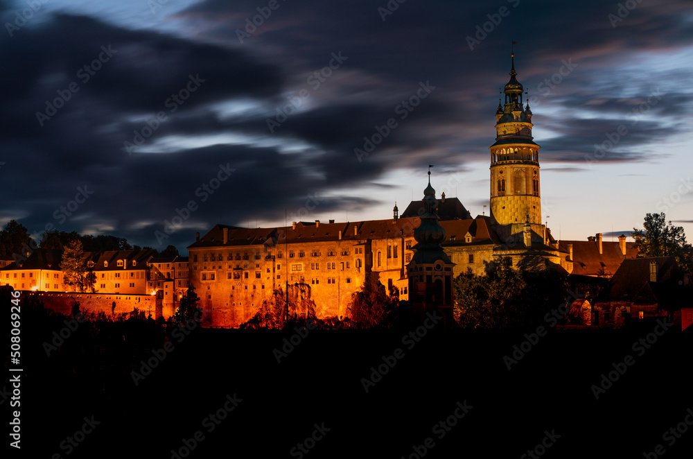 The view of the Český Krumlov castle and the town of Cesky Krumlov at night. Colorful clouds. South Bohemia, Czech Republic. 